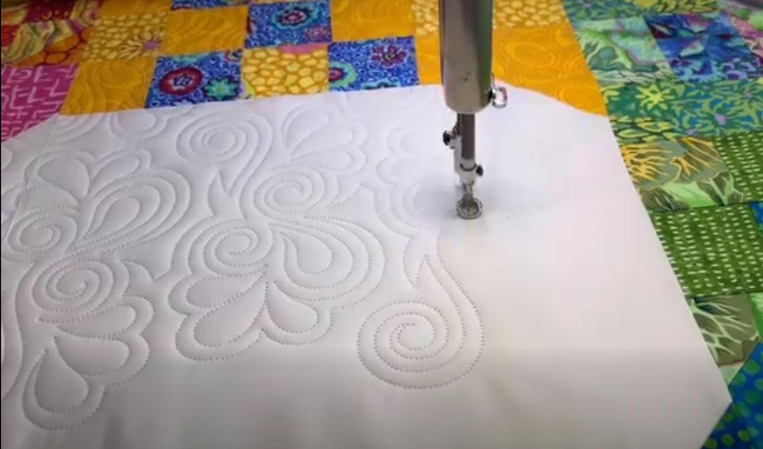 Our longarm machine creating beautiful floral quilting designs